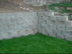 A brick wall with green grass